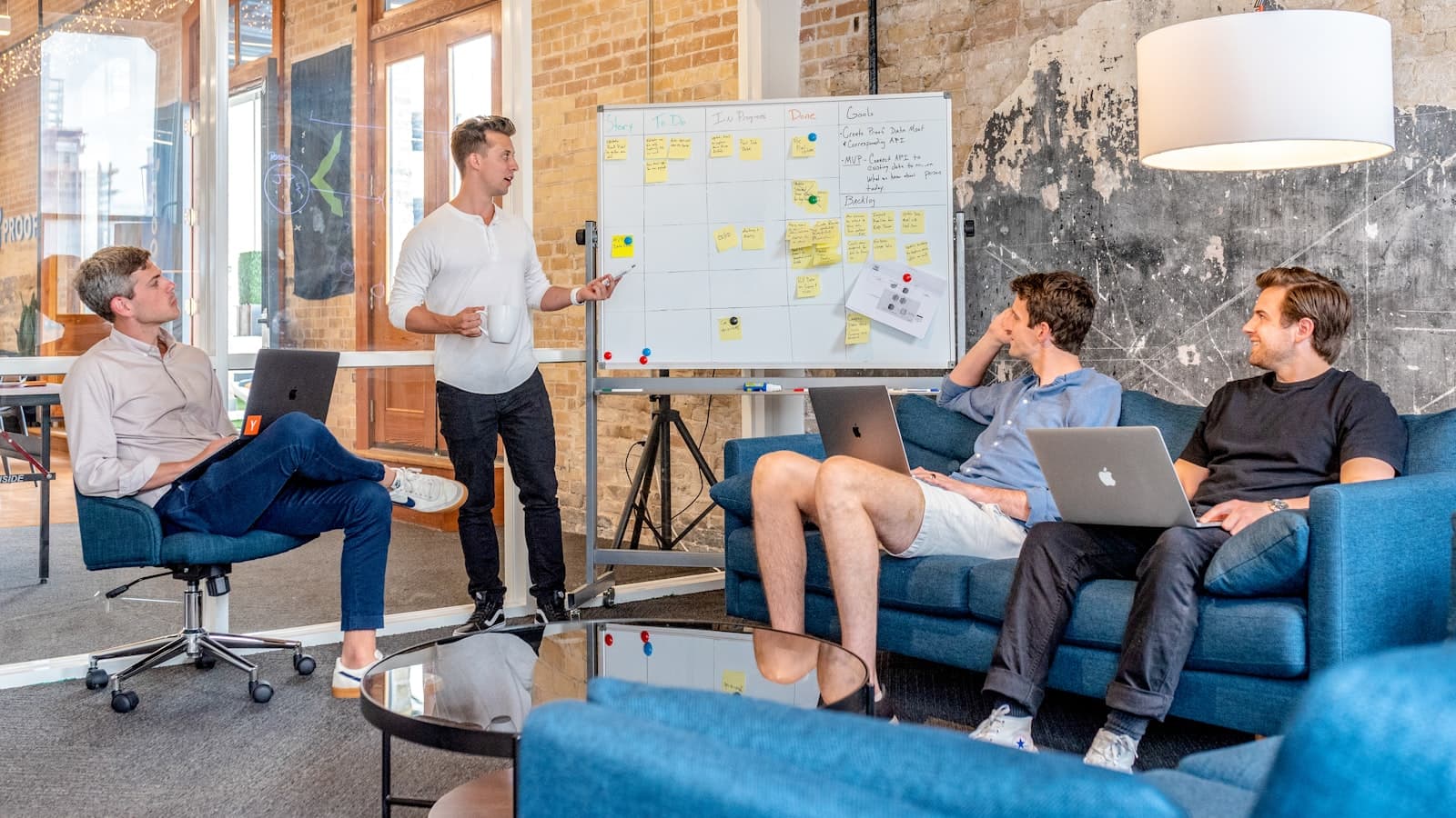 Absoluteli Digital creative team planning a campaign around a studio whiteboard